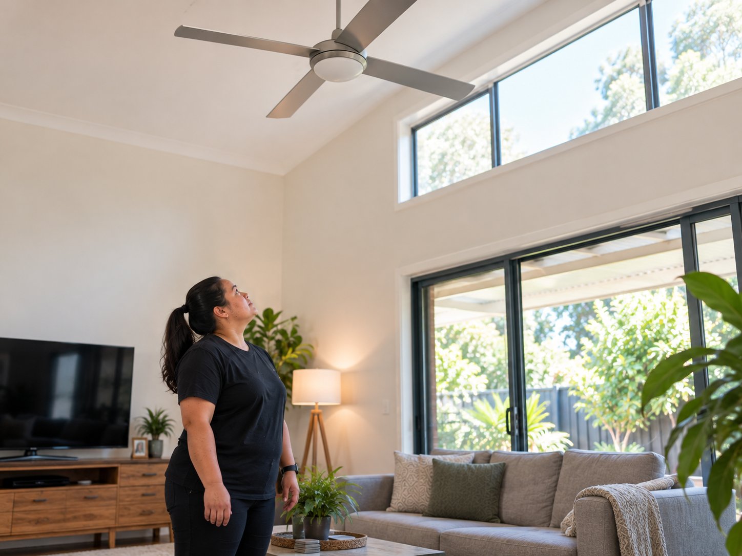 Support worker assessing a high window or ceiling fan that sits outside safe working-at-height limits